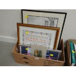 A box of framed prints and cross stitch embroidery
