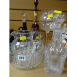 Three decanters, an etched ruby glass and two others, fruit bowl, jug etc