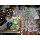 A large quantity of drinking glasses & coloured glass including green glass dressing table set