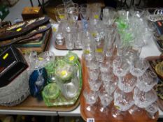 A large quantity of drinking glasses & coloured glass including green glass dressing table set
