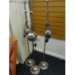 A trio of adjustable headed chrome standard lamps