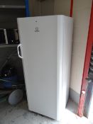 An Indesit tall fridge in white