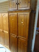 A honey pine double wardrobe and matching cupboard