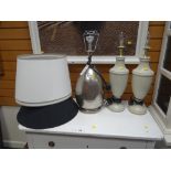 A pair of modern wooden urn shaped table lamps together with a beaten silver metal table lamp and