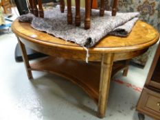 A reproduction cross-banded style oval coffee table with cane work lower tier