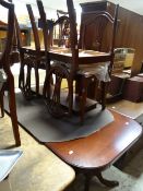 A reproduction mahogany effect twin-pedestal dining table and six shield back chairs
