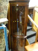 A good reproduction standing serpentine corner cupboard with glazed top
