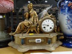 A gilt metal & marble mantel clock with a Roman noble lady seated next to circular clock face,