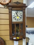 A vintage oak Vienna-style wall clock