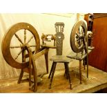 A CARVED SPINNING WHEEL CHAIR and two vintage spinning wheels (as seen)