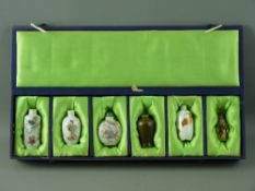 A COLLECTION OF SIX CHINESE PORCELAIN & CARVED STONE SNUFF BOTTLES in a satin lined case, three with