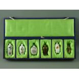 A COLLECTION OF SIX CHINESE PORCELAIN & CARVED STONE SNUFF BOTTLES in a satin lined case, three with