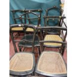 A PARCEL OF SEVEN CIRCA 1900 EBONIZED PARLOUR CHAIRS, four matching and one other with cane work