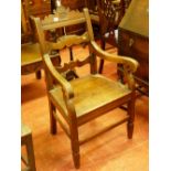 A 19th CENTURY OAK FARMHOUSE ARMCHAIR, the shaped top rail leaf carved and dated 1887 with shaped