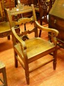 A 19th CENTURY OAK FARMHOUSE ARMCHAIR, the shaped top rail leaf carved and dated 1887 with shaped