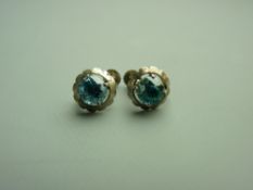 A PAIR OF STERLING SILVER BLUE ZIRCON STUD EARRINGS, the round faceted stones of approximately 7 x 7