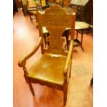 A CARVED EISTEDDFOD ARMCHAIR, the shaped top rail titled 'Eisteddfod Y-Plant Dinbych, 1927', the