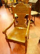 A CARVED EISTEDDFOD ARMCHAIR, the shaped top rail titled 'Eisteddfod Y-Plant Dinbych, 1927', the