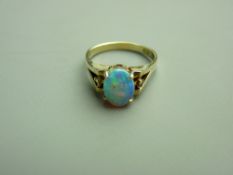 AN EIGHTEEN CARAT GOLD OPAL DRESS RING having an oval cabochon opal of approximately 9 x 7 mm,