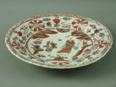 AN EARLY CHINESE STYLE SHALLOW BOWL decorated in the style of Cizhou ware, iron red and green