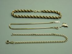 THREE MISCELLANEOUS GOLD BRACELETS - one muff, one box link and one round link and a nine carat gold