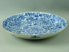 A CHINESE BLUE & WHITE PEONY DECORATED DISHED CHARGER, 35 cms diameter with simple leaf decoration