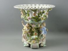 A CIRCA 1900 GERMAN PORCELAIN FRUIT COMPORT with rose adorned reticulated bowl on a Rococo style