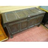 AN ANTIQUE OAK COFFER, the lidded top with four inset panels with iron nail hinges, interior