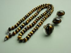 A TIGER'S EYE TRIO OF NECKLACE, 58 cms long, silver signet ring with cabochon tiger's eye and a pair