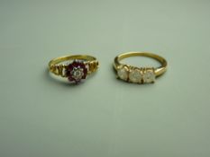 AN EIGHTEEN CARAT GOLD RUBY CLUSTER RING, 2.6 grms and a nine carat gold three stone diamond ring,