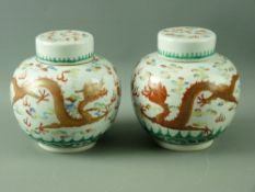 A PAIR OF 19th CENTURY CHINESE GINGER JARS & COVERS, decorated with opposing pairs of dragons