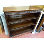 AN EDWARDIAN MAHOGANY BOOKCASE with adjustable interior shelves, blind fretwork top frieze and