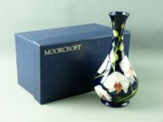 A MOORCROFT 'CHATSWORTH ORCHID' limited edition (291/350) bottle vase by Phillip Gibson, 23.5 cms
