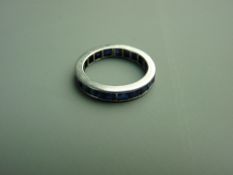 AN EIGHTEEN CARAT WHITE GOLD FULL ETERNITY SAPPHIRE RING having approximately twenty five square
