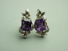 A PAIR OF FOURTEEN CARAT WHITE GOLD AMETHYST & DIAMOND STUD EARRINGS, each having an emerald faceted
