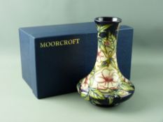 A MOORCROFT SQUAT VASE, designed by Sian Leeper, 20.5 cms high, tube line decoration on a purple