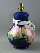 A MOORCROFT 'MAGNOLIA' LARGE POTTERY TABLE LAMP, decorated on a cobalt ground, impressed to the base