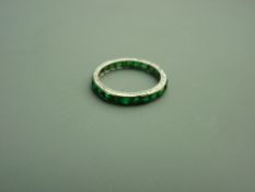A PLATINUM & EMERALD FULL ETERNITY RING having approximately twenty three square faceted emeralds,