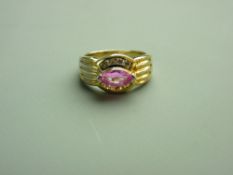 A FOURTEEN CARAT GOLD DRESS RING with ridged shoulders and having an oval pink sapphire solitaire