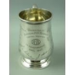 A HALLMARKED SILVER PRESENTATION PINT TANKARD of baluster form with scroll handle, Birmingham