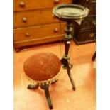 AN EBONIZED EMPIRE STYLE BOWL STAND and a rise and fall piano stool with circular top, the stand