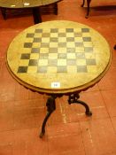 A VICTORIAN WALNUT & CAST IRON GAMES TABLE, the 48 cms diameter top having burr walnut veneer and