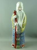 A LARGE CHINESE PORCELAIN FIGURINE OF SHOU, THE STAR GOD'S ROBES, decorated in rich enamel