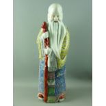 A LARGE CHINESE PORCELAIN FIGURINE OF SHOU, THE STAR GOD'S ROBES, decorated in rich enamel