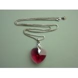 AN ARTIST'S DESIGNED HEART SHAPED RED SWAROVSKI CRYSTAL with silver and black decoration and with