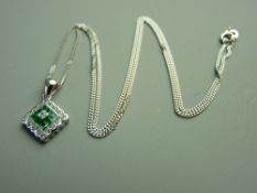AN EIGHTEEN CARAT WHITE GOLD EMERALD & DIAMOND KITE SHAPED CLUSTER PENDANT with fine link chain, the