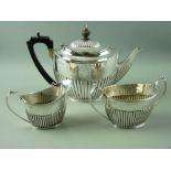 A NEAR MATCHED HALLMARKED SILVER THREE PIECE TEA SERVICE of teapot by Elkington & Co, Birmingham