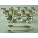 EIGHT HALLMARKED SILVER NAPKIN RINGS, four EPNS and a pair of sugar tongs, 4 troy ozs weighable