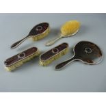 A FIVE PIECE SILVER & TORTOISESHELL BACKED DRESSING TABLE SET of hand mirror and two pairs of