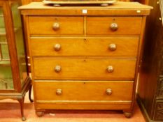 A VICTORIAN MAHOGANY CHEST of two short over three long drawers with turned wooden knobs, raised